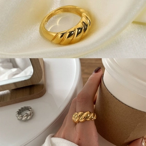 Polished stainless steel croissant ring set in gold and silver with twisted texture finish