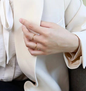Elegant gold wavy stackable rings shown on model fingers for a minimalist look