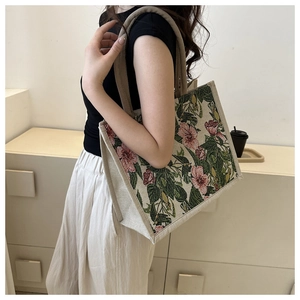Detail of floral jacquard tote bag with woven cotton rope handles and vintage pattern