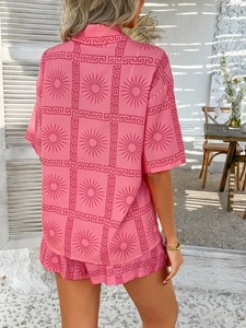 Detailed view of pink bohemian geometric print short set worn on a Mediterranean balcony