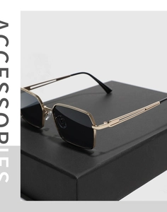 Detailed macro view of gold metal square sunglasses frames with anti-slip texture and dark lenses
