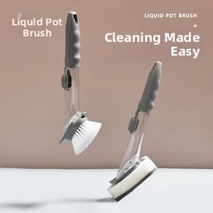 Detail of long handle kitchen brush with dual brush heads and liquid soap dispenser