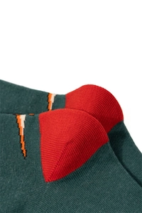 Detailed macro view of the knitted fabric texture and heel stitching on a green cotton sock