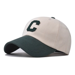 Close-up of contrast beige and green cotton baseball cap with 3D letter C embroidery
