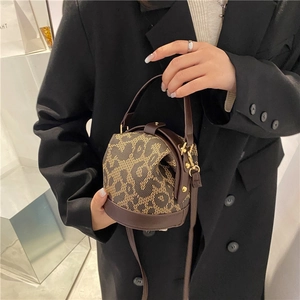 Fashion leopard print canvas barrel handbag with leather trim and shoulder strap