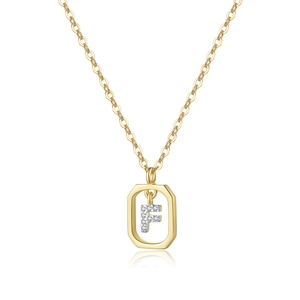 Macro shot of gold octagonal pendant featuring a crystal-encrusted letter F on a fine chain