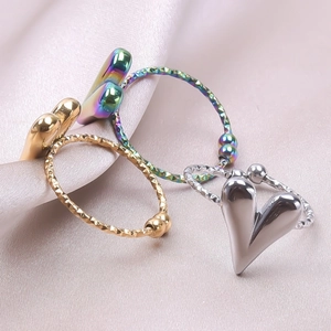Polished stainless steel heart rings in gold, silver and colorful finishes with silk background