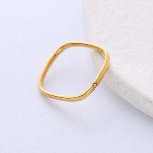 Minimalist gold square titanium steel ring with a small cubic zirconia on a stone base
