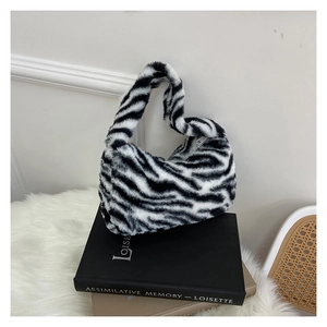 Close-up of zebra pattern plush handbag detail showing soft texture and high-quality fabric
