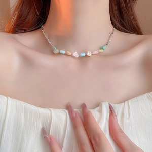 Detailed view of colorful natural stone necklace on a model with elegant soft lighting