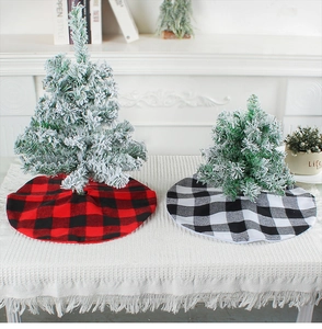 Detail of red and black checkered Christmas tree skirts on a festive tabletop display