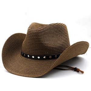 Detail of dark brown woven straw cowboy hat featuring silver studs on a black leather band
