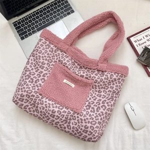 Detail of pink leopard print tote bag featuring fuzzy texture pocket and plush handles