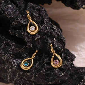 Detailed macro view of 18K gold plated teardrop pendants with colorful zircon stones