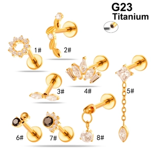 Eight premium G23 titanium gold piercing studs with sparkling zircon inlays on white backdrop