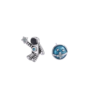 Asymmetric astronaut and planet stud earrings with blue enamel and sparkling zircon
