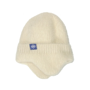 Detail of cream white knit earflap hat with soft plush texture and snowflake patch