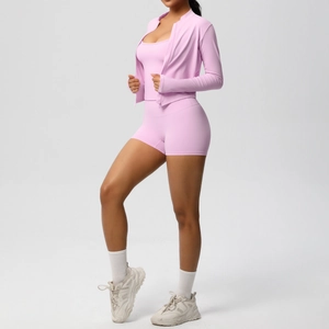 Three-piece pale pink yoga set featuring a zip jacket, tank top, and high-waisted shorts