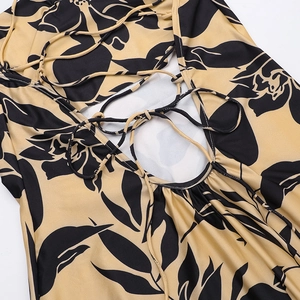 Detailed view of the backless tie-up design and floral print on this maxi dress