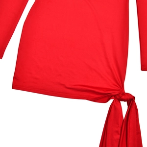Detailed close-up of the red dress showing side tie-knot and soft pleated fabric texture
