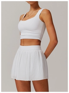 Detail view of white tennis set with side pleated tank top and matching pleated mini skirt