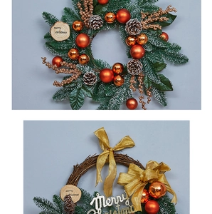 Detail of Christmas wreath with gold bow, pine cones, and Merry Christmas sign