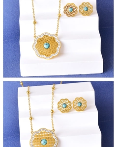 Detail of vintage gold hollow flower jewelry set with turquoise and white rhinestones