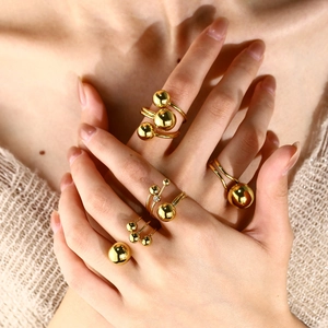 Polished gold spherical stackable rings featuring minimalist geometric dome design for women