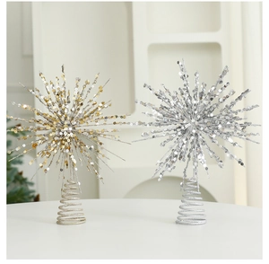 Close-up of glittery champagne star tree topper with a spiral spring base for Christmas