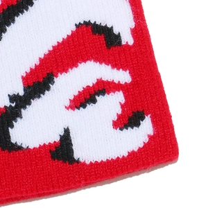 Macro view of thickened rib-knit texture with red, white, and black jacquard pattern