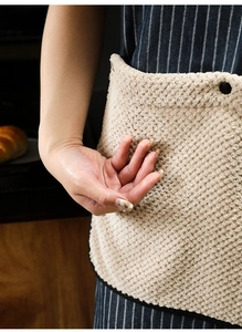 Close-up of beige kitchen apron showing the water-absorbent coral fleece hand towel detail