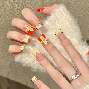 Handmade press-on nails featuring floral 3D art and tiger patterns in pink and orange