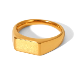 Macro shot of gold square signet ring showing brushed metal texture on white background
