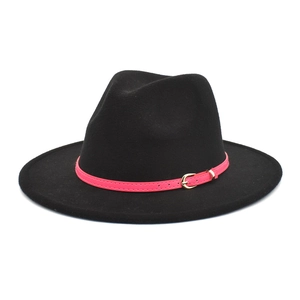 Detail of black wool fedora hat featuring a bright pink belt and golden metal buckle