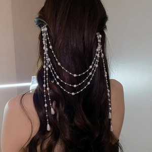 Elegant pearl tassel hair clip with multiple strands and drop pearls on a model's hair