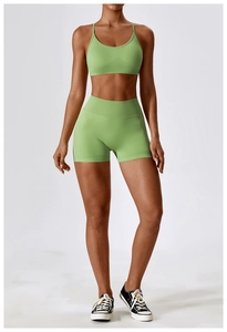 Close-up of seamless light green yoga set with high-waist shorts and thin straps top
