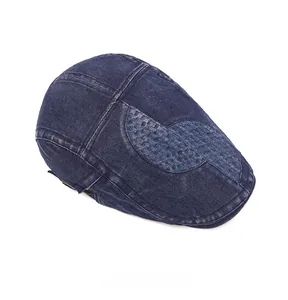 Top view of blue denim newsboy cap featuring detailed woven texture and washed edges