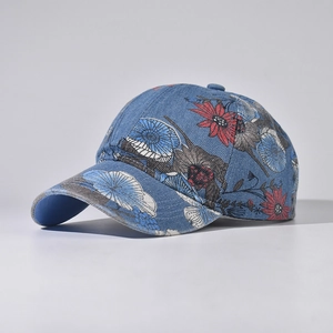 Side view of denim baseball cap featuring vintage floral patterns and curved brim