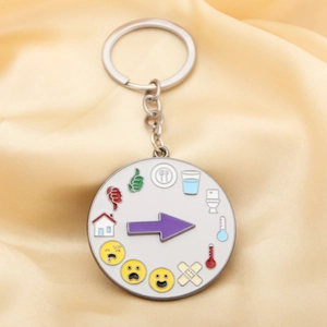 Detail of metal rainbow wheel keychain with rotating arrow for mood and social battery