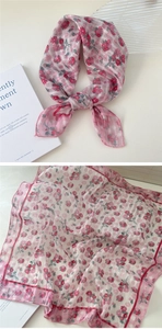 Detail of pink floral cotton linen square scarf showing fabric texture and knotting style