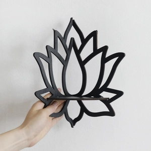 Detail of a black lotus wooden wall shelf with small display ledge held against a wall