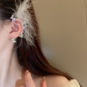 Detail of silver bow feather ear cuff with sparkling rhinestones worn on ear