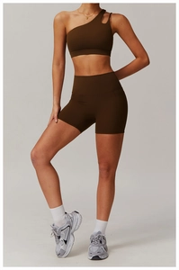 Detail view of coffee brown one-shoulder sports bra and high-waist biker shorts set