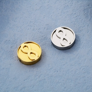 Macro detail of 15mm gold and silver stainless steel infinity charms for DIY jewelry making