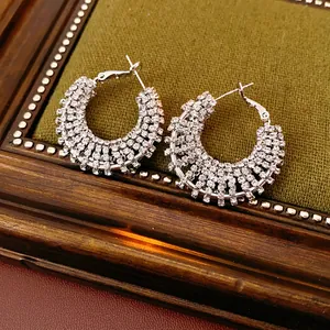 Elegant silver-colored C-shaped hoop earrings encrusted with sparkling rhinestones for women