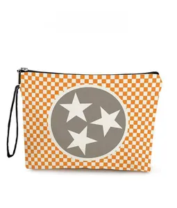 Macro view of checkered star makeup bag featuring orange grid pattern and zipper detail