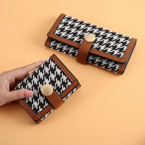 Long and short houndstooth wallets with brown leather trim and metal clasp closure