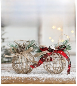 Christmas hollow iron sphere ornament with pine needles, cones and a rustic burlap bow