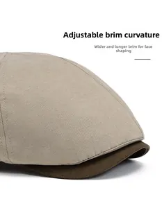 Detail of adjustable curved brim on two-tone newsboy hat showing cotton fabric texture
