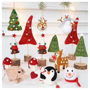 Collection of handmade wool felt Christmas ornaments featuring reindeer and snowman